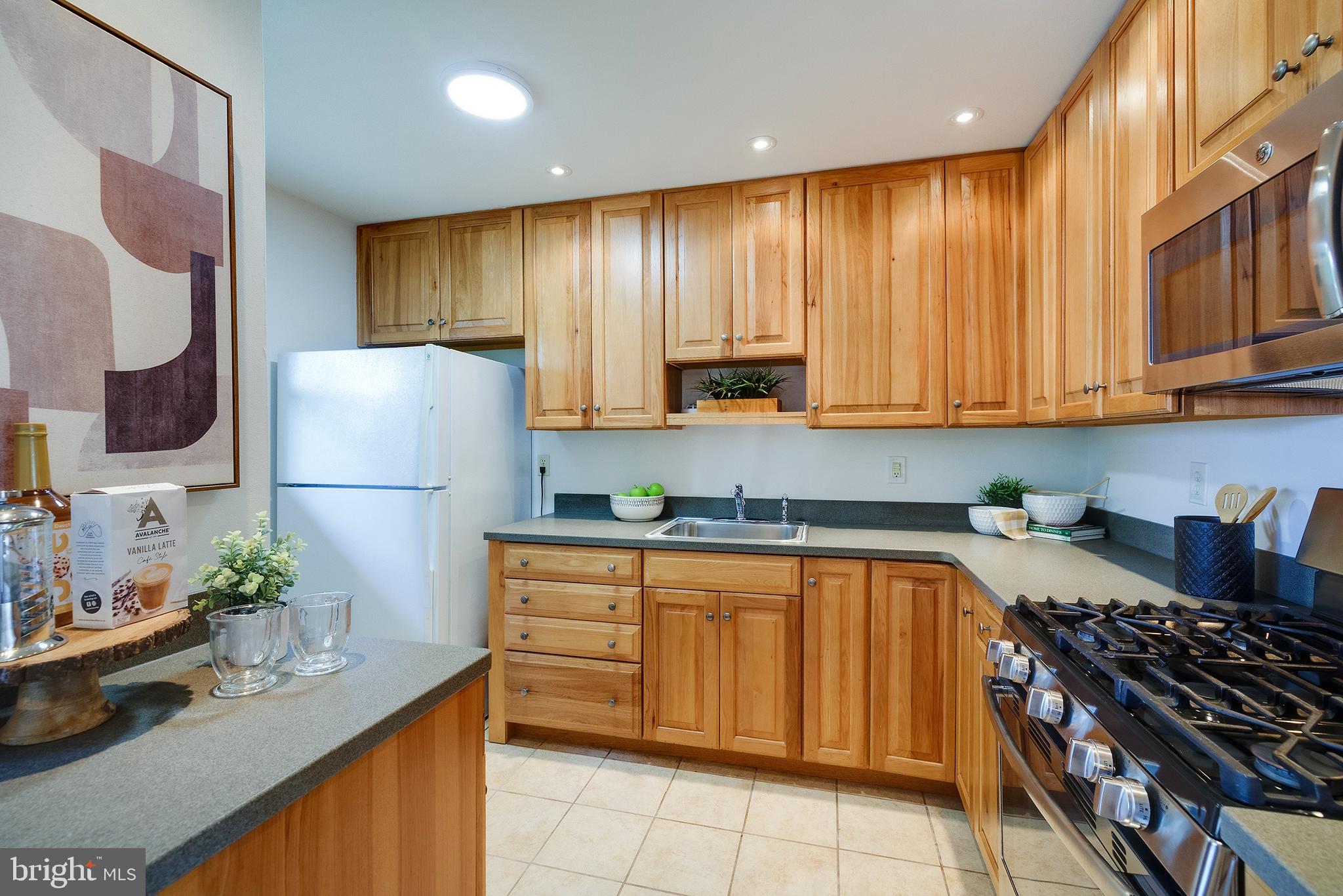 9212 Morley Road Lanham, MD 20706 - Photo 19 of 64 a kitchen with stainless steel appliances granite countertop a refrigerator sink and cabinets