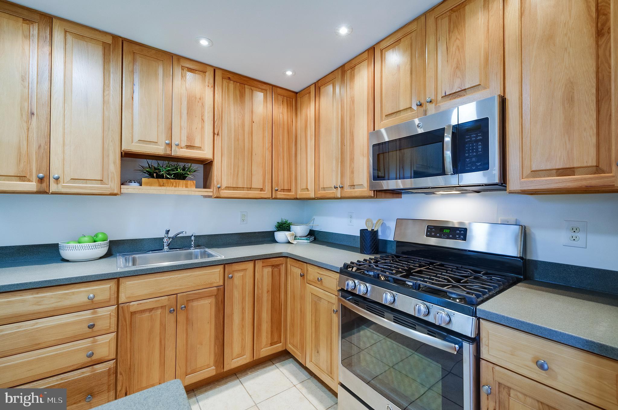 9212 Morley Road Lanham, MD 20706 - Photo 20 of 64 a kitchen with stainless steel appliances granite countertop a stove a microwave and cabinets