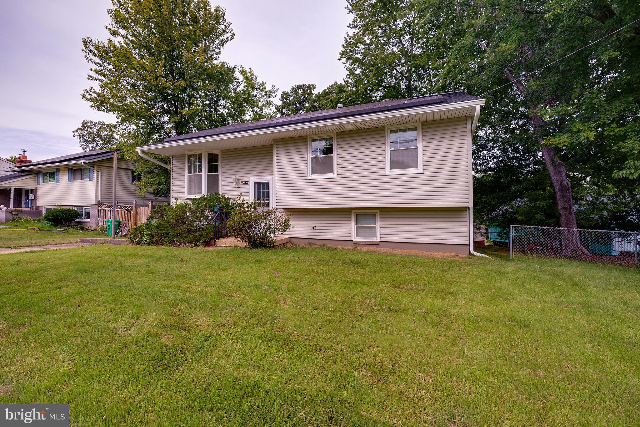 9212 Morley Road Lanham, MD 20706 - Photo 2 of 64 a backyard of a house with barbeque oven and outdoor seating