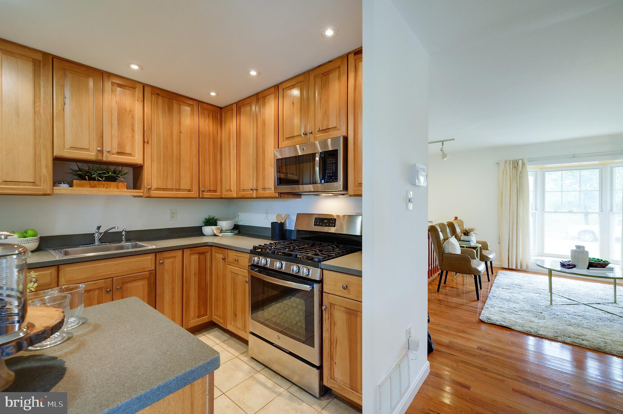 9212 Morley Road Lanham, MD 20706 - Photo 21 of 64 a kitchen with a stove a sink and a microwave