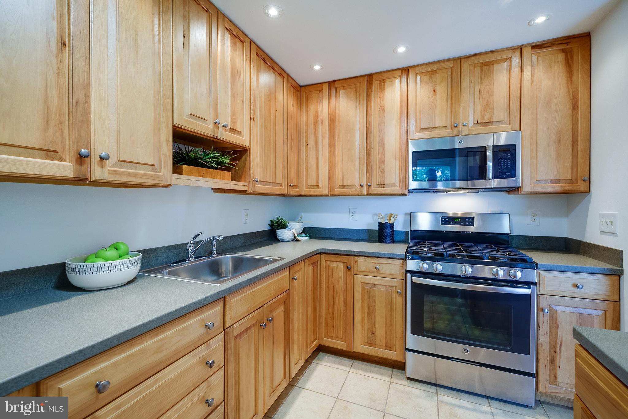 9212 Morley Road Lanham, MD 20706 - Photo 24 of 64 a kitchen with stainless steel appliances granite countertop a stove a sink and a microwave
