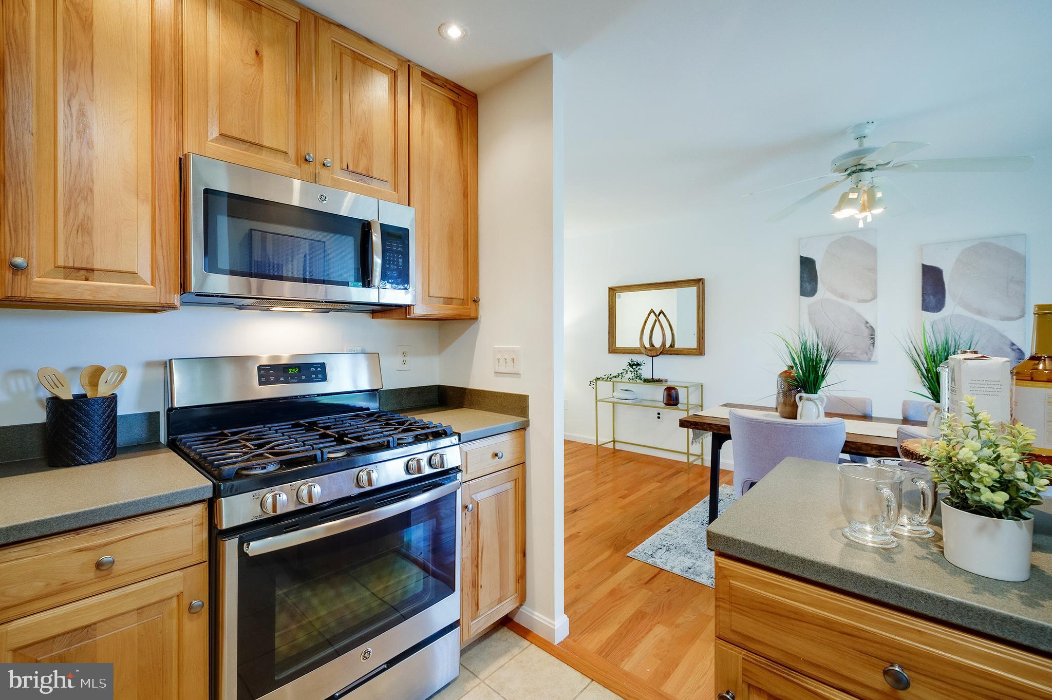 9212 Morley Road Lanham, MD 20706 - Photo 26 of 64 a kitchen with stainless steel appliances granite countertop a stove a microwave a sink and cabinets
