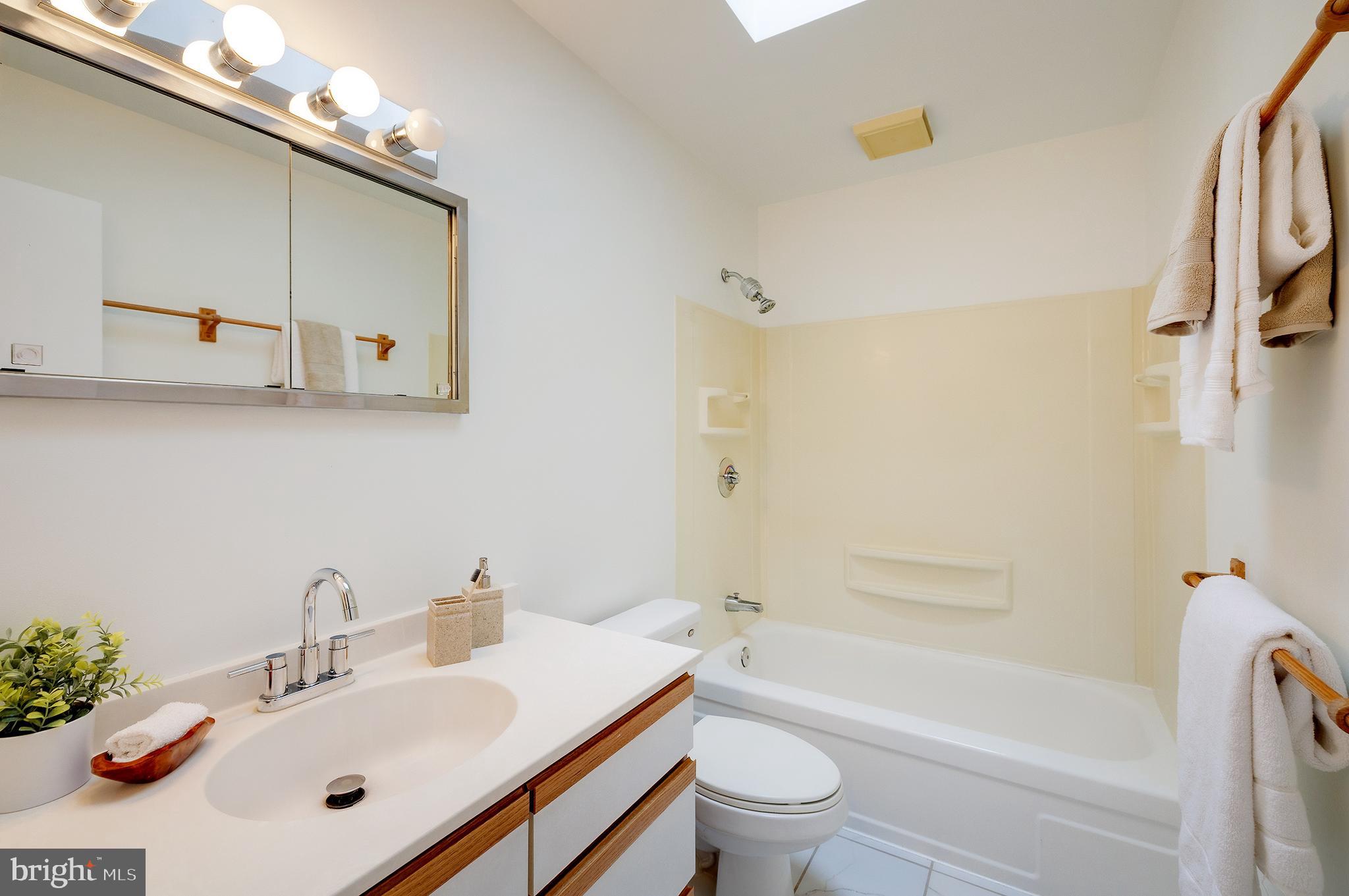 9212 Morley Road Lanham, MD 20706 - Photo 37 of 64 a bathroom with a sink mirror toilet and bathtub