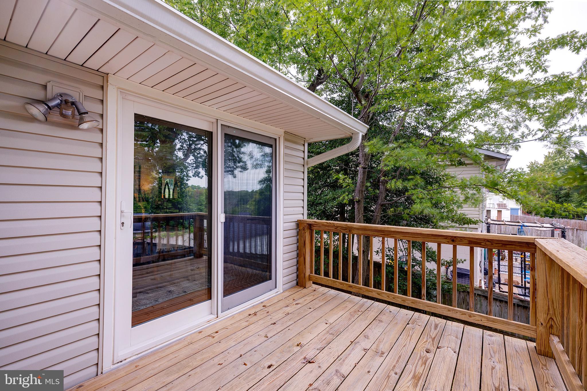 9212 Morley Road Lanham, MD 20706 - Photo 49 of 64 a balcony with wooden floor and outdoor space