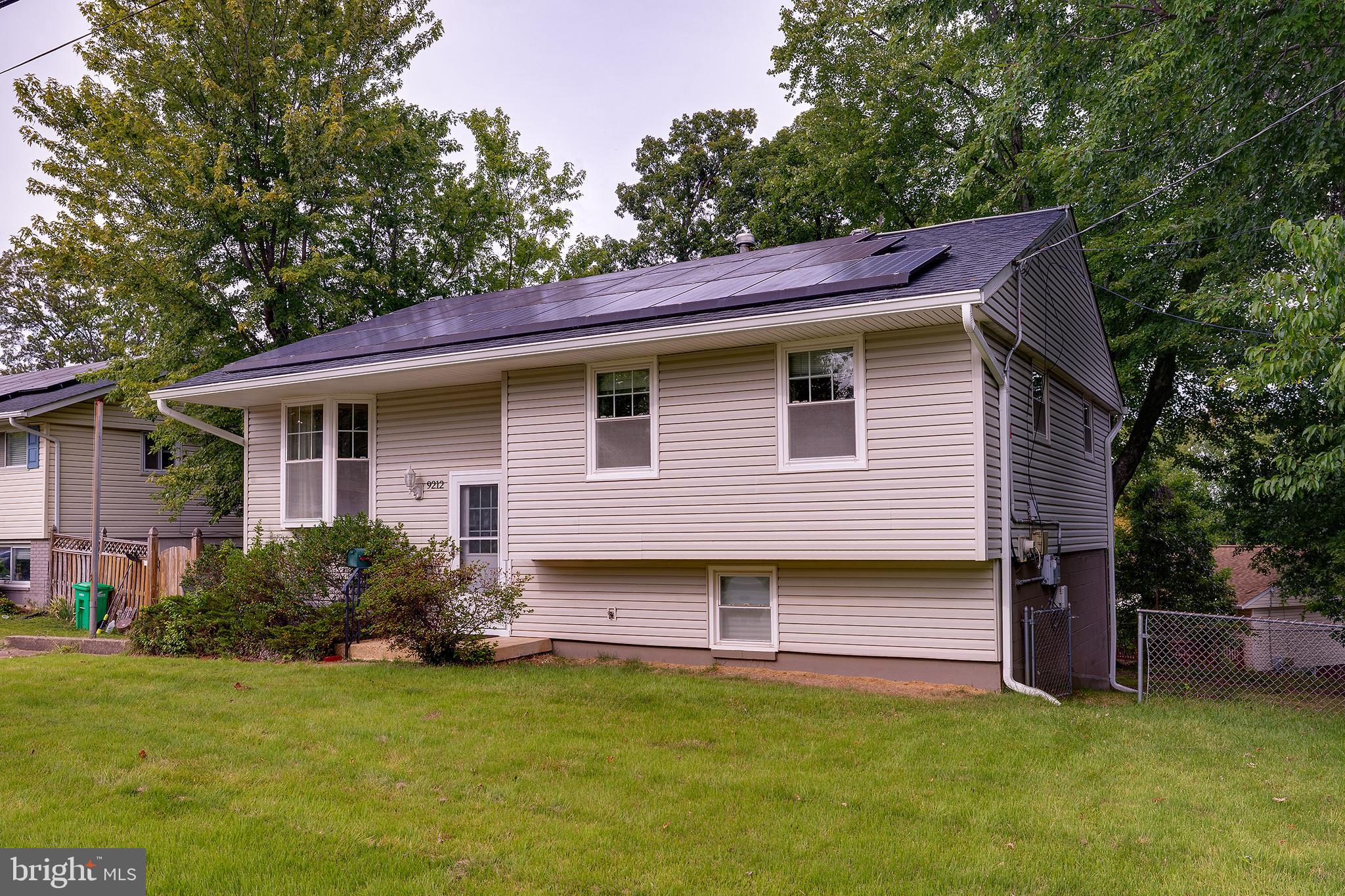 9212 Morley Road Lanham, MD 20706 - Photo 6 of 64 a view of a house with a yard plants and large tree