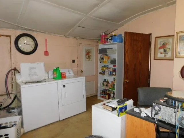 a room with furniture a clock and a view of kitchen