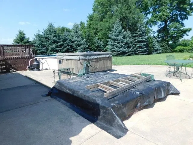 a view of a patio with table and chairs with wooden fence