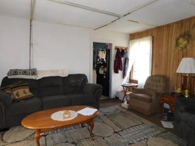 a living room with furniture a rug and a window