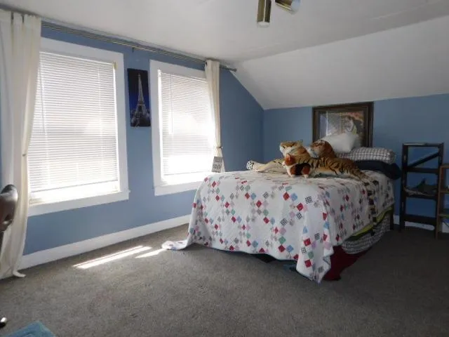 a bedroom with a bed lamp and window