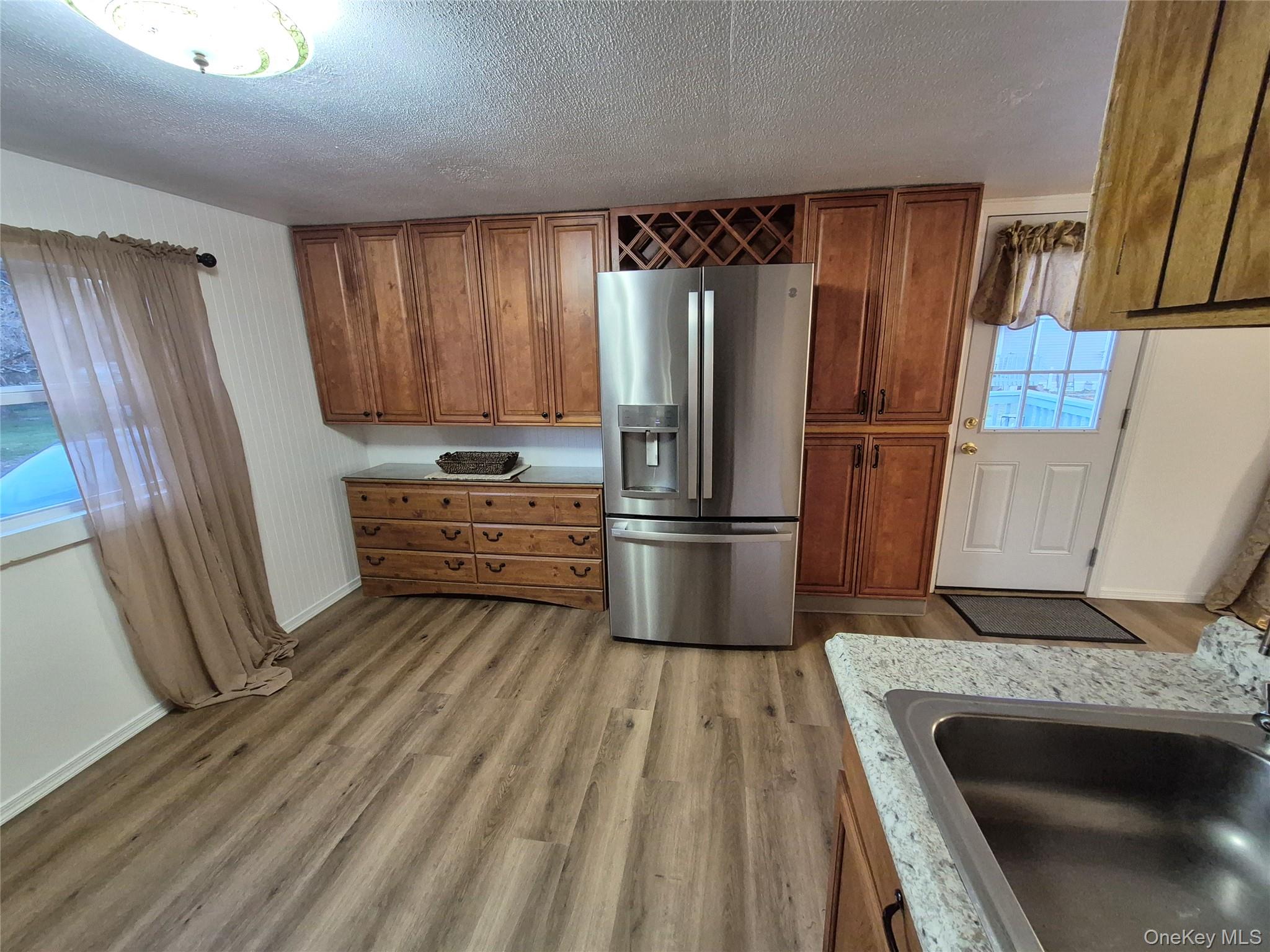 363 Mettacahonts Road, Unit 5 Accord, NY 12404 - Photo 13 of 39 a kitchen with granite countertop a refrigerator and a sink