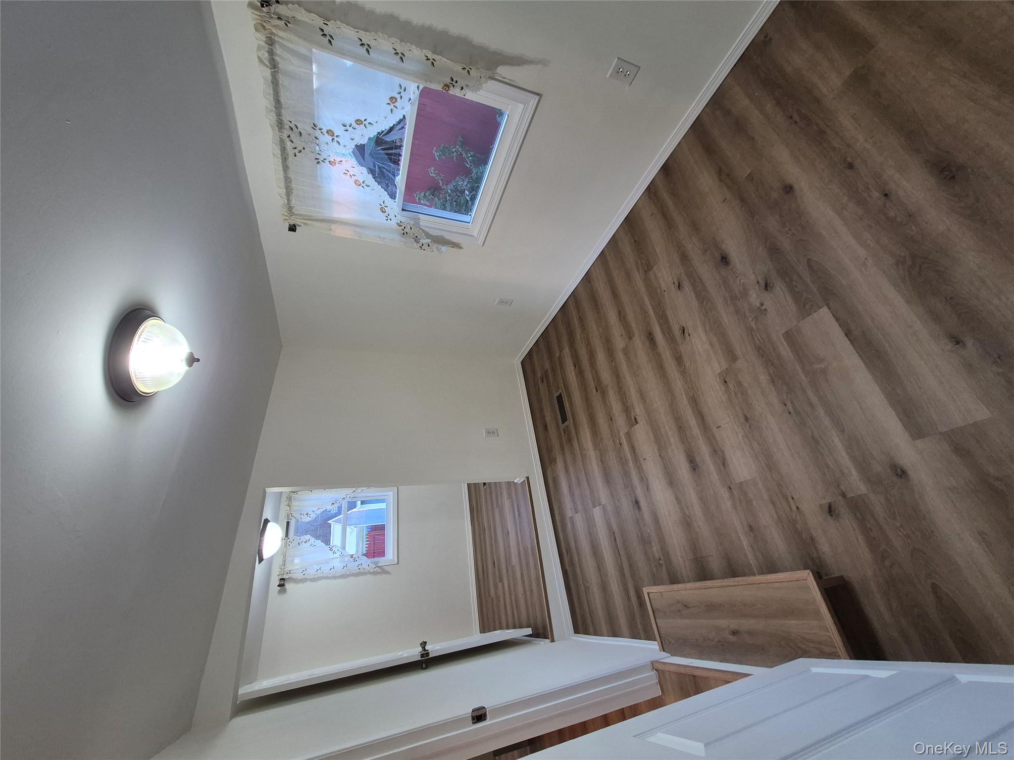 363 Mettacahonts Road, Unit 5 Accord, NY 12404 - Photo 28 of 39 a view of an empty room with wooden floor and a window
