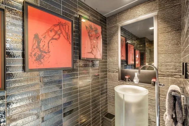 a bathroom with a toilet sink and mirror