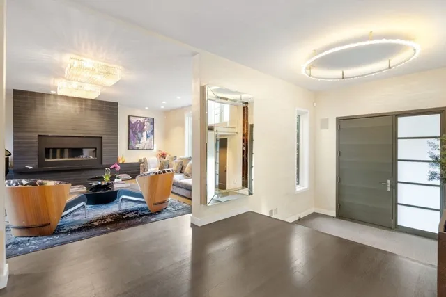 a living room with furniture wooden floor and a fireplace