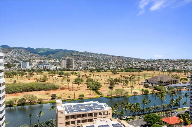 a bathroom with a granite countertop sink a mirror a toilet and a shower