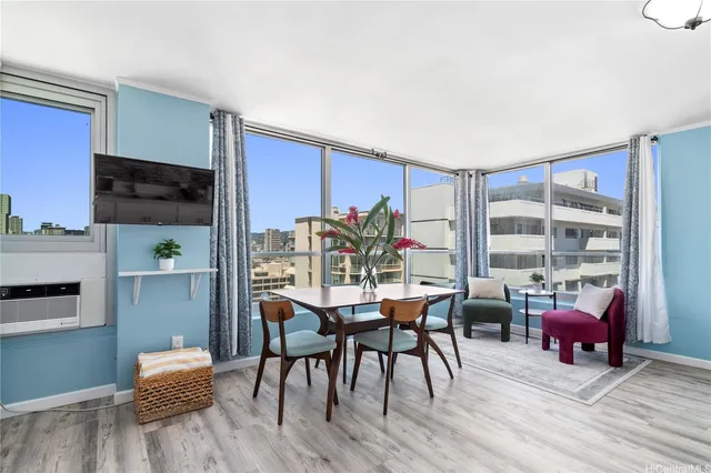 a view of a dining room with furniture and wooden floor