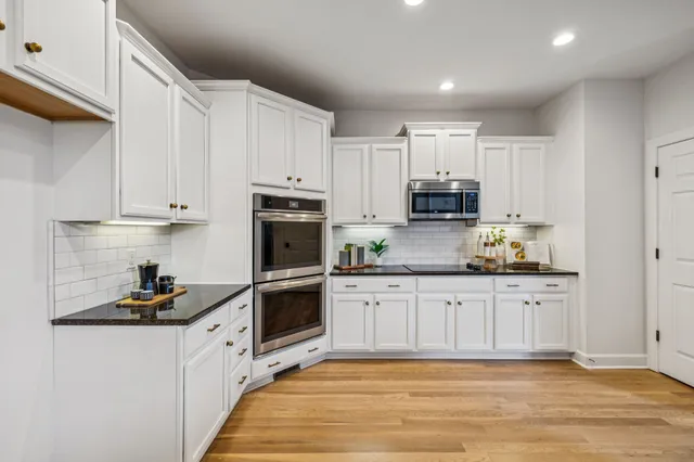 a front view of a brick house with a yard