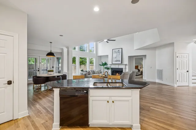 a view of a room with wooden floor and small window
