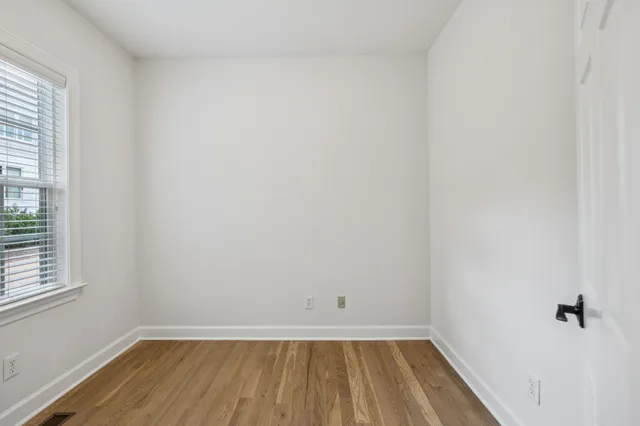 a view of walk in closet with empty racks