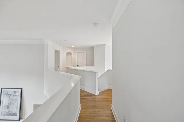 an empty room with wooden floor and outdoor space