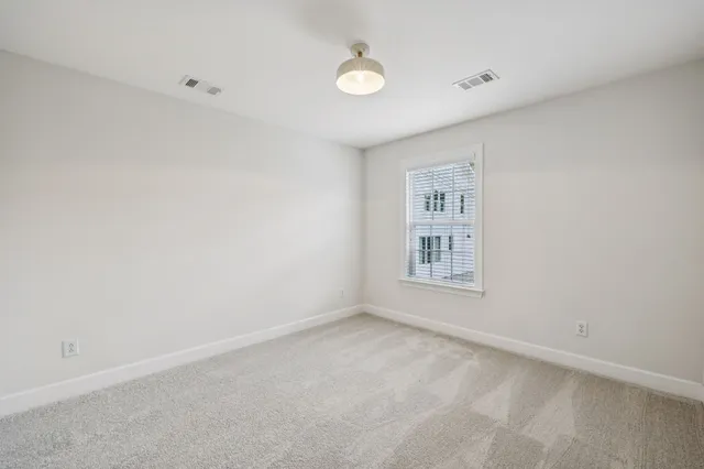 a view of a backyard with wooden fence