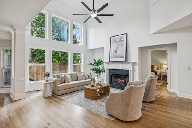 a dining room with furniture a chandelier and wooden floor