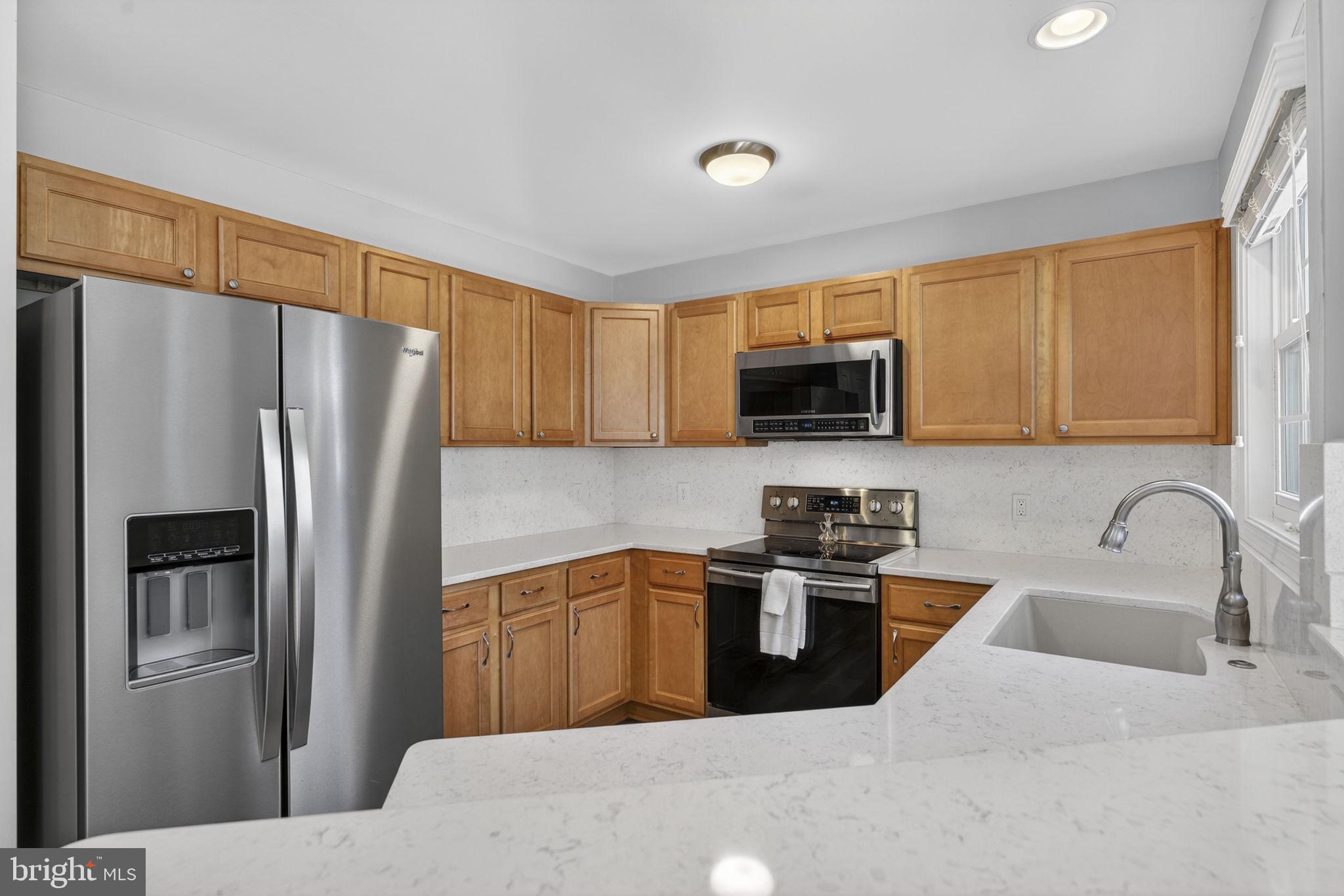 19707 Old Orange Road Culpeper, VA 22701 - Photo 14 of 40 a kitchen with stainless steel appliances granite countertop a refrigerator stove top oven a sink and dishwasher