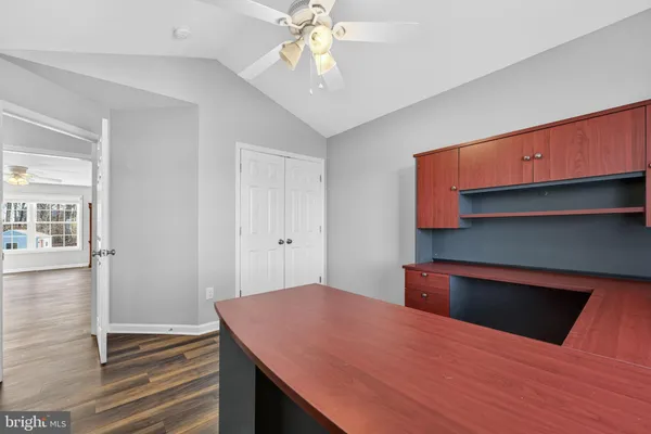 a room with kitchen island a sink and wooden floor