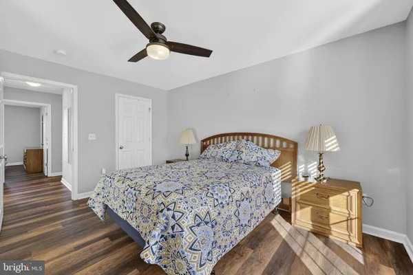 a bedroom with bed and wooden floor