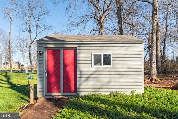 a view of a house with a yard and tree