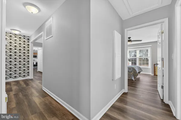 a view of hallway with wooden floor