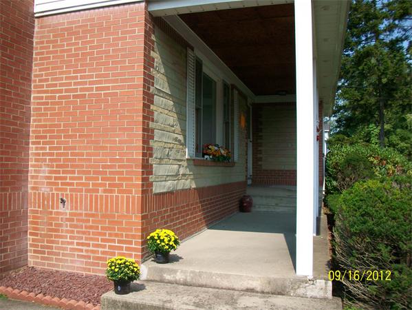 10 Senator Street Springfield, MA 01129 - Photo 3 of 21 a view of a brick house with potted plants