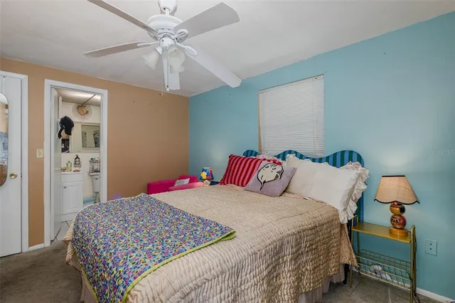 a bedroom with a bed and a lamp