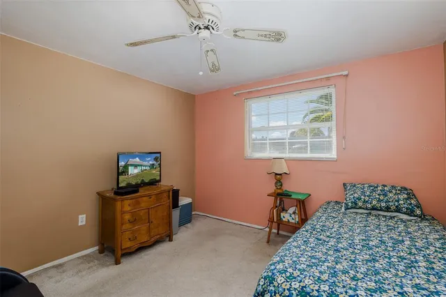 a bedroom with bed and window