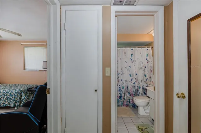 a bathroom with a toilet a sink and a mirror