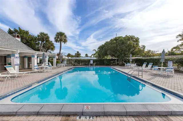 a view of a swimming pool with a lounge chair