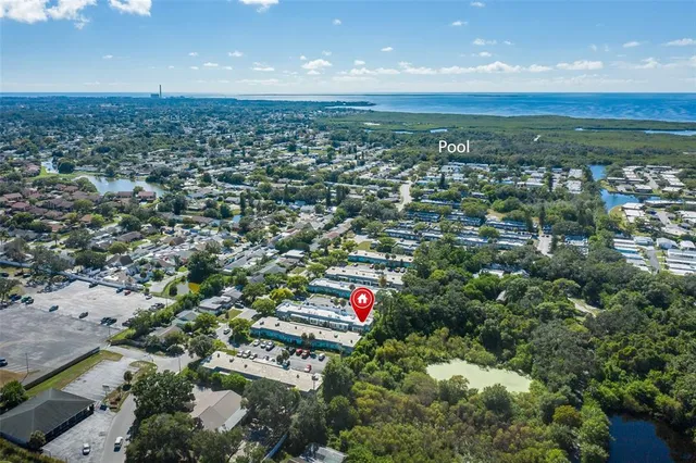 an aerial view of residential houses with outdoor space and trees