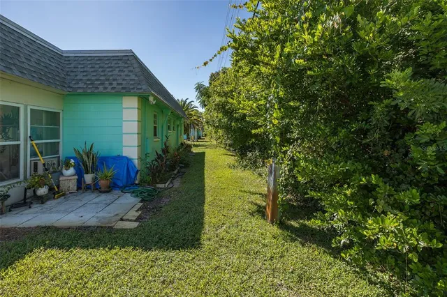 a view of a backyard with plants and a patio