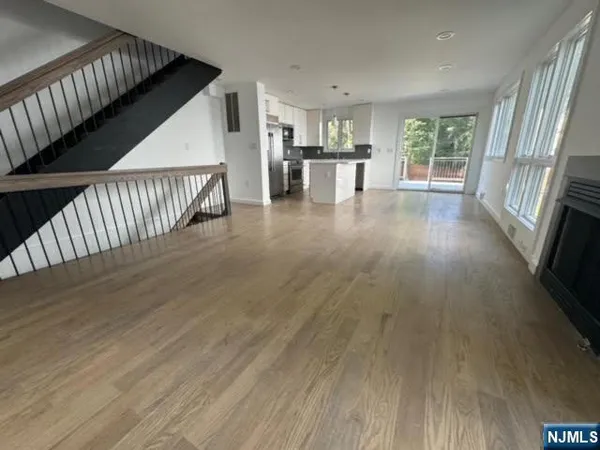 a view of kitchen with wooden floor and electronic appliances