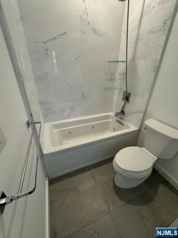 a utility room with a stove and a sink