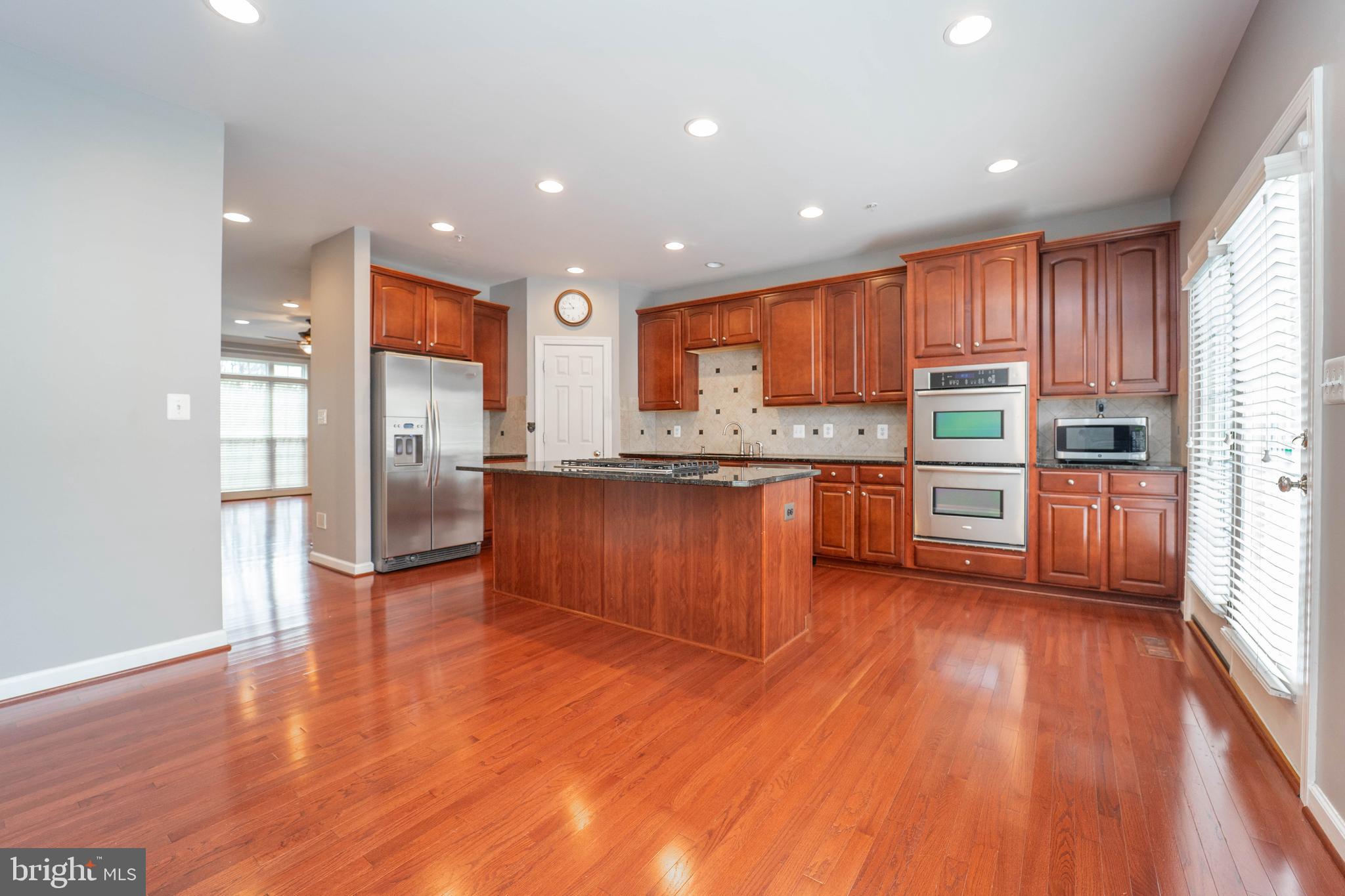 321 Bulwark Alley Annapolis, MD 21401 - Photo 19 of 58 a kitchen with stainless steel appliances granite countertop a refrigerator a sink dishwasher and a stove with wooden floor