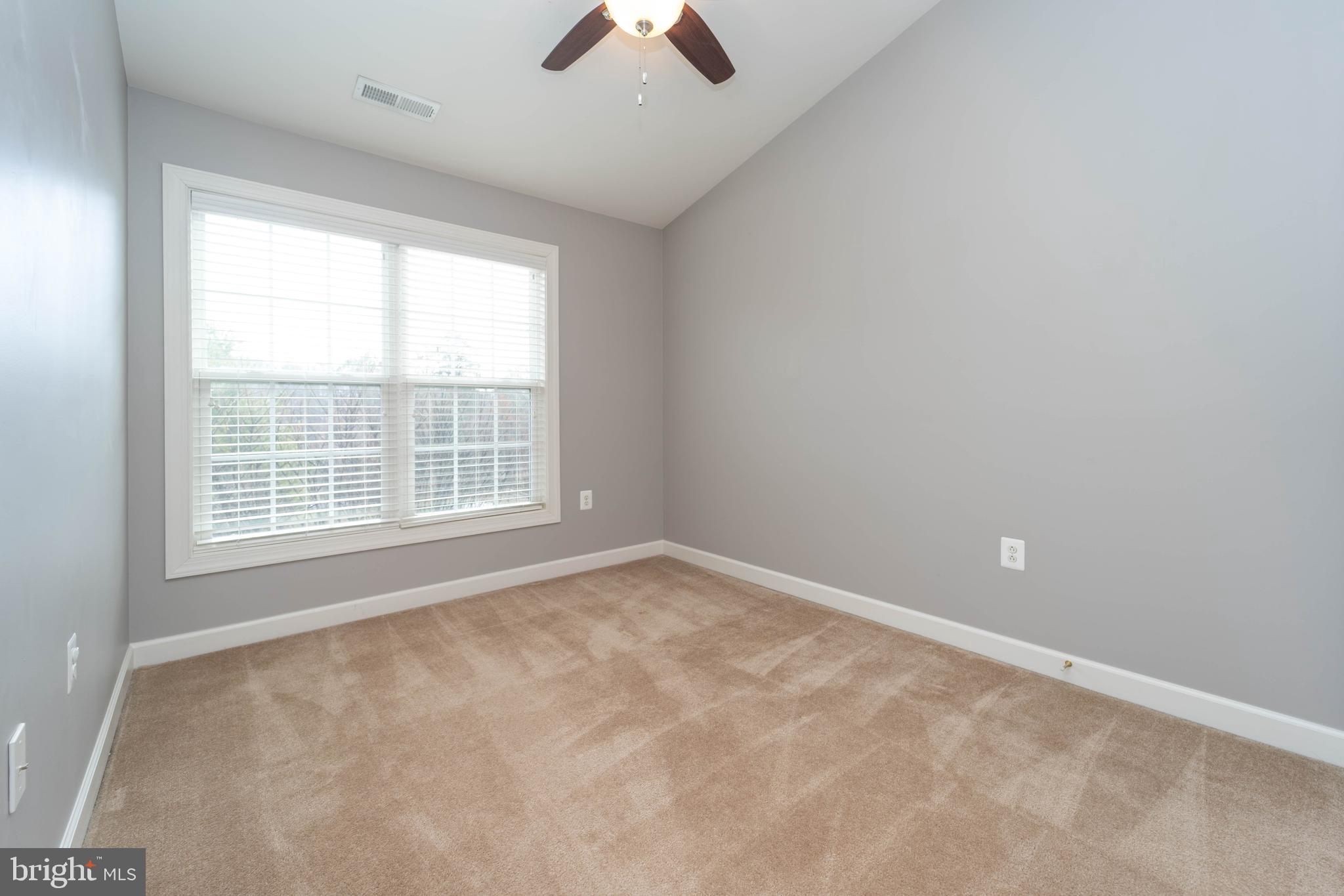 321 Bulwark Alley Annapolis, MD 21401 - Photo 36 of 58 an empty room with chandelier fan and windows