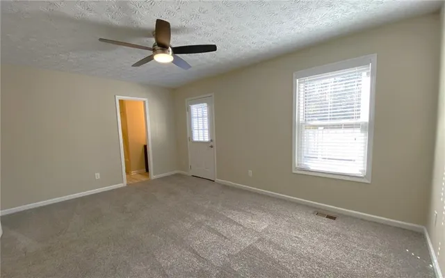 a bathroom with a granite countertop shower a toilet and a sink