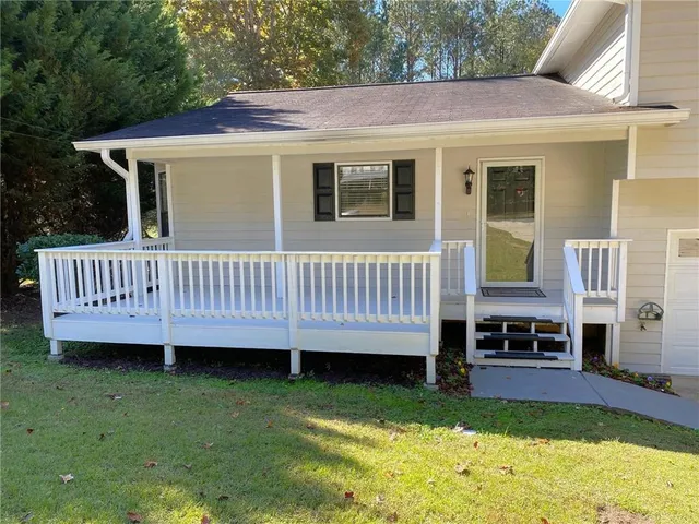 a view of a house with a backyard and porch