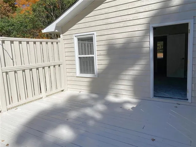 an empty room with closet and a chandelier fan