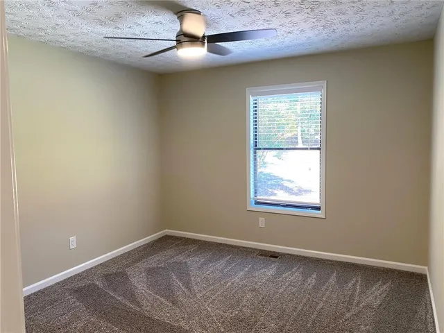 a view of a yard with a trees in the background