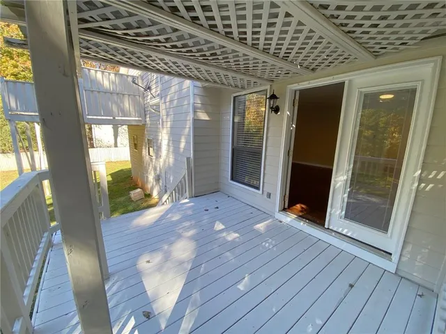 a view of a patio with table and chairs and potted plants