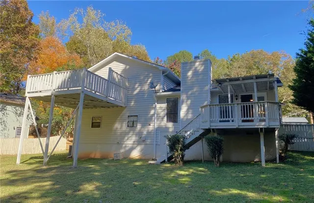 an aerial view of house with yard and mountain view in back