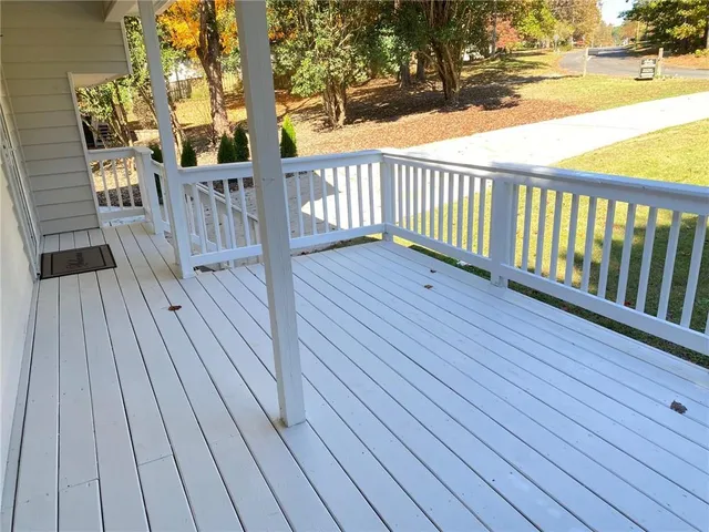 a bathroom with a granite countertop sink a mirror and a bathtub