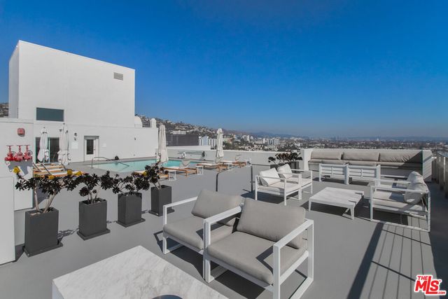 a view of a swimming pool and a back yard
