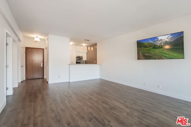 a view of a kitchen with a sink and a refrigerator